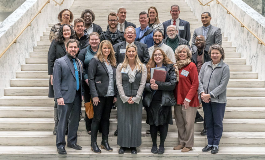 A group of Habitat staff gather on the steps in the capitol for lobby day 2019