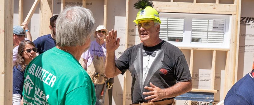 Volunteers discuss strategy at a blitz build work site